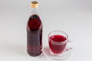 Non-alcoholic drink in bottle and cup of fruit drink