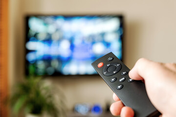 Men watching television in the living room. Viewing the television series at home. The choice of TV channel