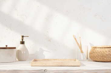 Space for product display on beige empty tray with various toiletries on wooden table against...