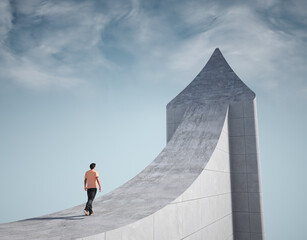 Man climbs a giant arrow pointing to the sky.