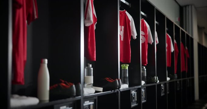Change, interior and empty locker room with sport jersey, water bottle and fitness equipment. Soccer, gym and uniform at club with clothes, shoes and football cleats in dressing closet for storage