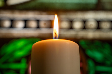 One candle flame at night in church closeup - isolated, macro.