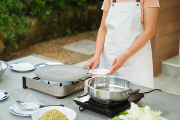 Portrait of a woman cooking in the garden. - Powered by Adobe