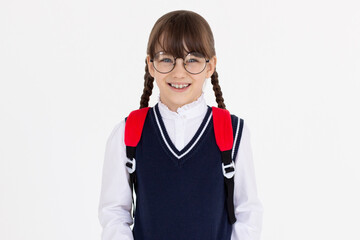 Indoor picture of young good-looking teenage girl isolated on white background in school uniform, wearing glasses and red backpack, feeling relaxed and positive, willing to walk