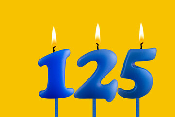 Blue candle number 125 - Birthday on yellow background