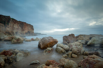 Praia do Molhe, rocks and fog,  Ferragudo Portimao Algarve.