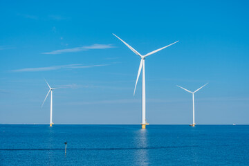 Fototapeta premium Wind Turbines Generating Renewable Energy in the Dutch Waters at Sunrise