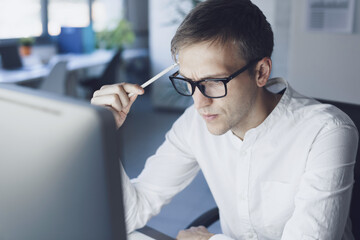 Businessman working with his computer and thinking