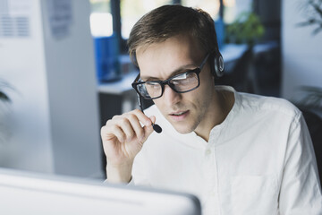 Office worker with headset connecting online