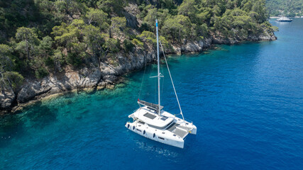 Stunning drone shot of a catamaran navigating the open sea