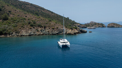 Stunning drone shot of a catamaran navigating the open sea