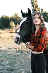 A young girl and her faithful friend, an Irish Cob, enjoy a moment together against the backdrop of...