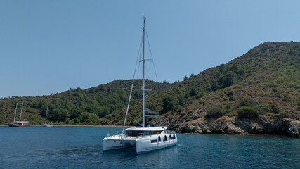 The beauty of a catamaran cruising, seen from above.