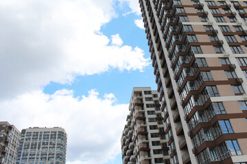 office building, modern office building, new apartment building on the background of a cloudy blue sky., 