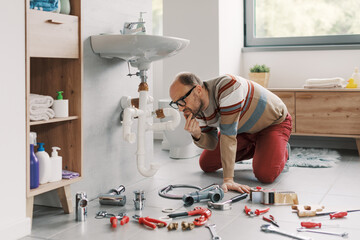 Man failing at DIY plumbing at home