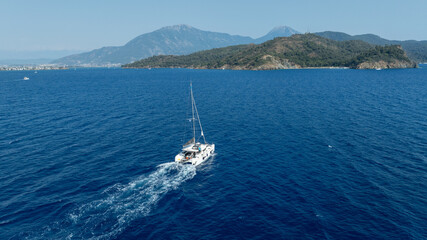  catamaran sailing gracefully, captured by a drone.