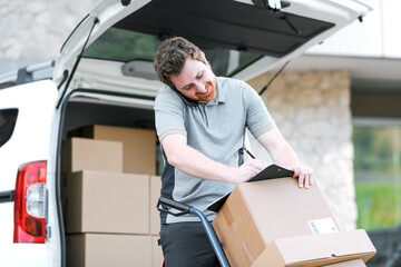 Professional delivery man having a phone call and signing delivery documents