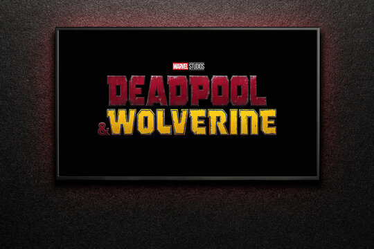 Wolverine and Deadpool trailer or movie on TV screen. TV on black textured wall. Astana, Kazakhstan - July 31, 2024.
