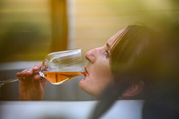 A woman enjoys a glass of wine while relaxing in a hot tub