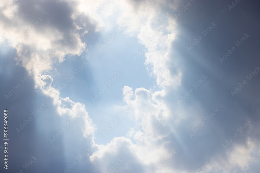 Wall mural the sky is filled with clouds and the sun is shining through them