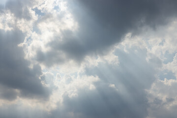 The sky is cloudy and the sun is shining through the clouds