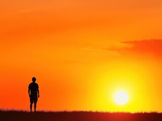 Fototapeta premium Silhouetted figure stands against vibrant sunset over rolling hills in tranquil evening
