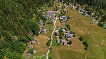 Aerial view of Val di Mello, a green valley surrounded by granite mountains and woods, renamed the...