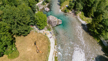 Aerial view of Val di Mello, a green valley surrounded by granite mountains and woods, renamed the...