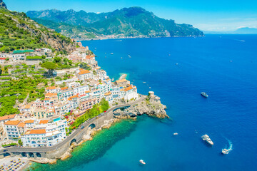 Naklejka premium Amalfi on Amalfi Coast, Italy. Aerial photo of famous city Amalfi located on Amalfi Coast with blue sea water and beautiful colorful houses on the cliff
