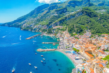 Naklejka premium Amalfi on Amalfi Coast, Italy. Aerial photo of famous city Amalfi located on Amalfi Coast with blue sea water and beautiful colorful houses on the cliff