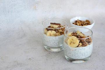 a couple of glasses of chia pudding with banana and oatmeal copy space 