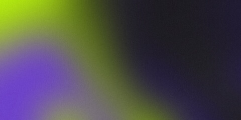 A blurry image of a purple and green color with a black background