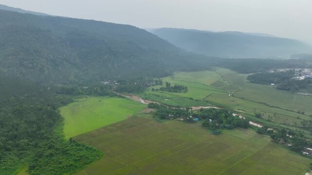 Aerial view of  rolling hills covered in lush green vegetation