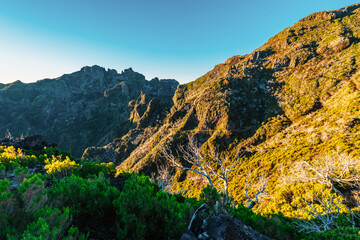 Hiking on the highest peak of Madeira Pico Ruivo next to the cottage Abrigo do Pico Ruivo. Views of...