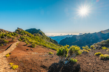 Hiking on the highest peak of Madeira Pico Ruivo next to the cottage Abrigo do Pico Ruivo. Views of...