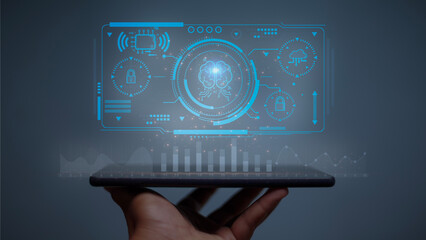 A hand holding a tablet with a blue screen showing a graphic of a person's brain. Concept of...
