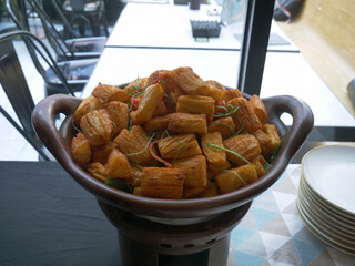 fried cassava cheese in a clay wadh on the table.