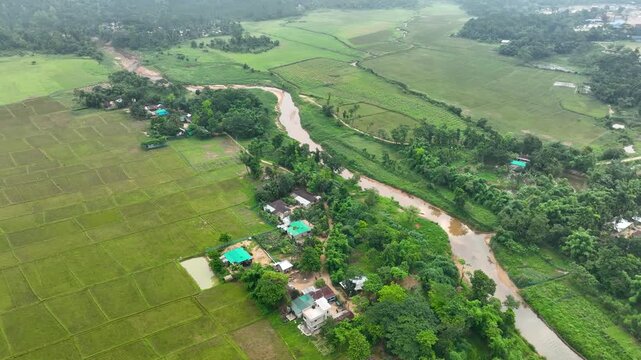 Idyllic Hillside Rural Landscape with Fields,Houses and Winding Waterway Aerial Footage