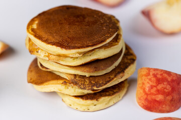 milk pancakes with butter and sliced peach slices