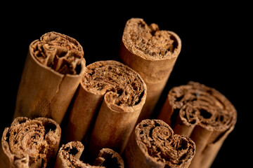 Thick wooden cinnamon on a black slate board