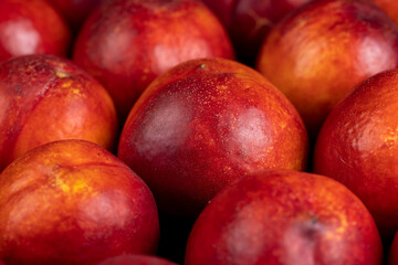 a large number of ripe soft nectarine fruits on the table