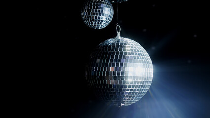 Close-up of a spinning disco ball reflecting dynamic rays of light against a black background. Perfect for creating a vibrant and energetic atmosphere at parties and events.