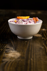 natural yogurt in a white bowl with fruits