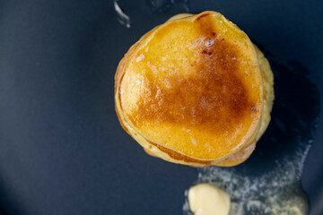 milk pancakes with butter on a blue plate
