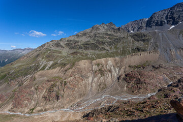 Summer alpine panorama of Vallelunga glacier 1850 moraines with stream at the bottom of the valley. Vallelunga, Alto Adige - Sudtirol, Italy. The glaciers are in rapid retreat caused by global warming