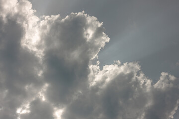 Storm cloud with sunshine behind it, developing over Harrington Beach State Park, Belgium,...