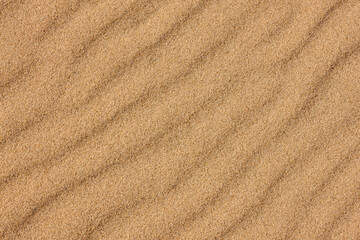 The rippled beach sand, partially frozen, runs diagonally on the beach at Harrington Beach State Park, Belgium, Wisconsin in late November