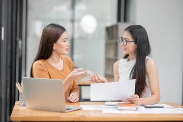 Asian business woman Discussing business documents in the office
