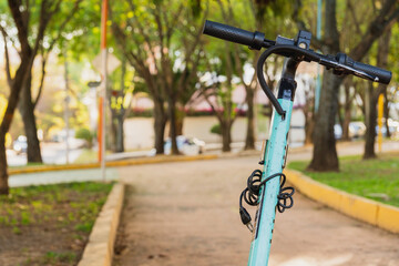 Fototapeta premium Close up on an electric scooter parked on a bike path in a public park