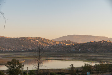 View of a lagoon at sunset, lagoon surrounded by mountains, cochabamba city bolivia